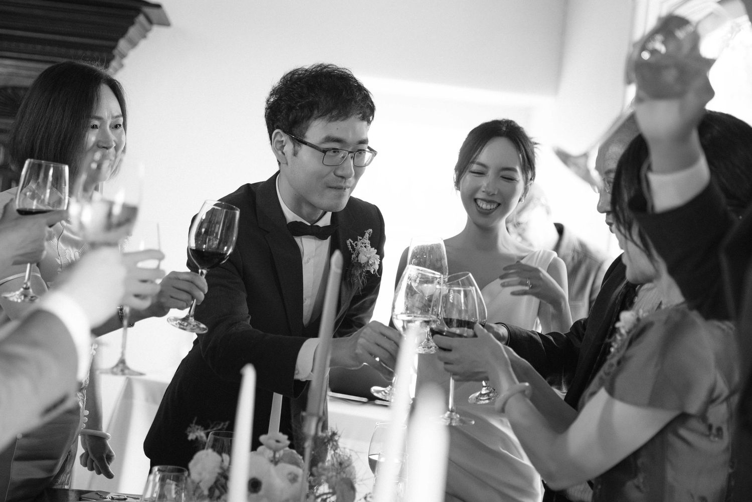 Wedding guests enjoying drinks and conversation at an indoor celebration.