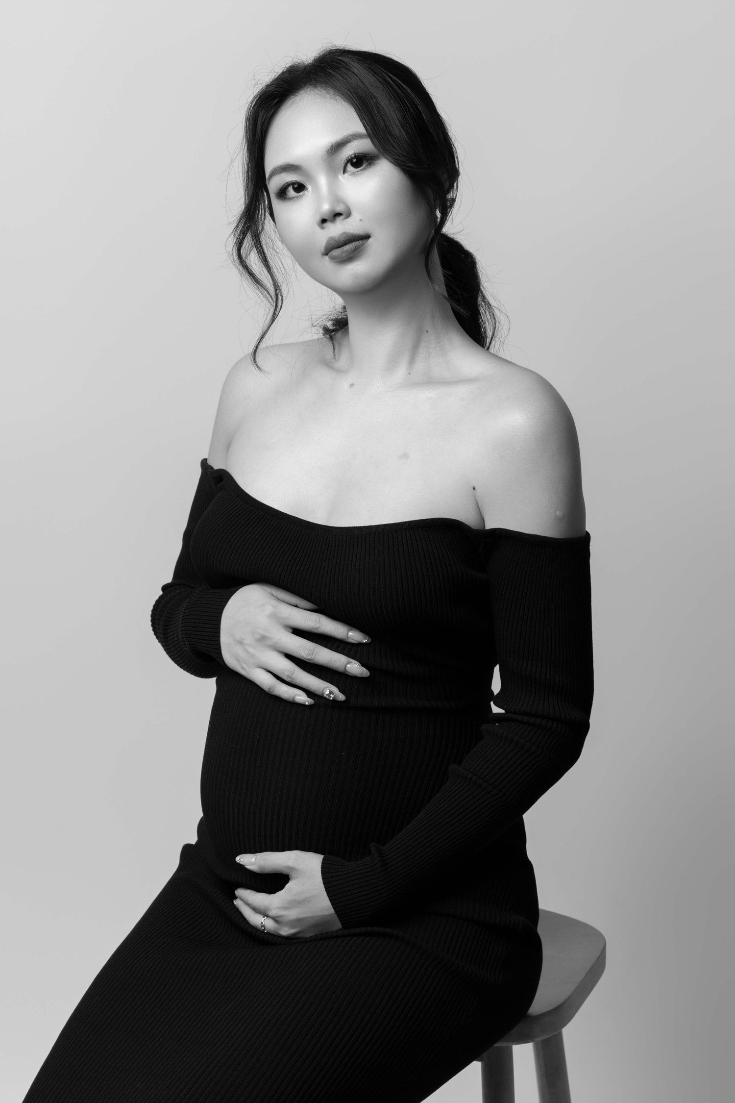 Dramatic black and white portrait series with off-shoulder black dress.