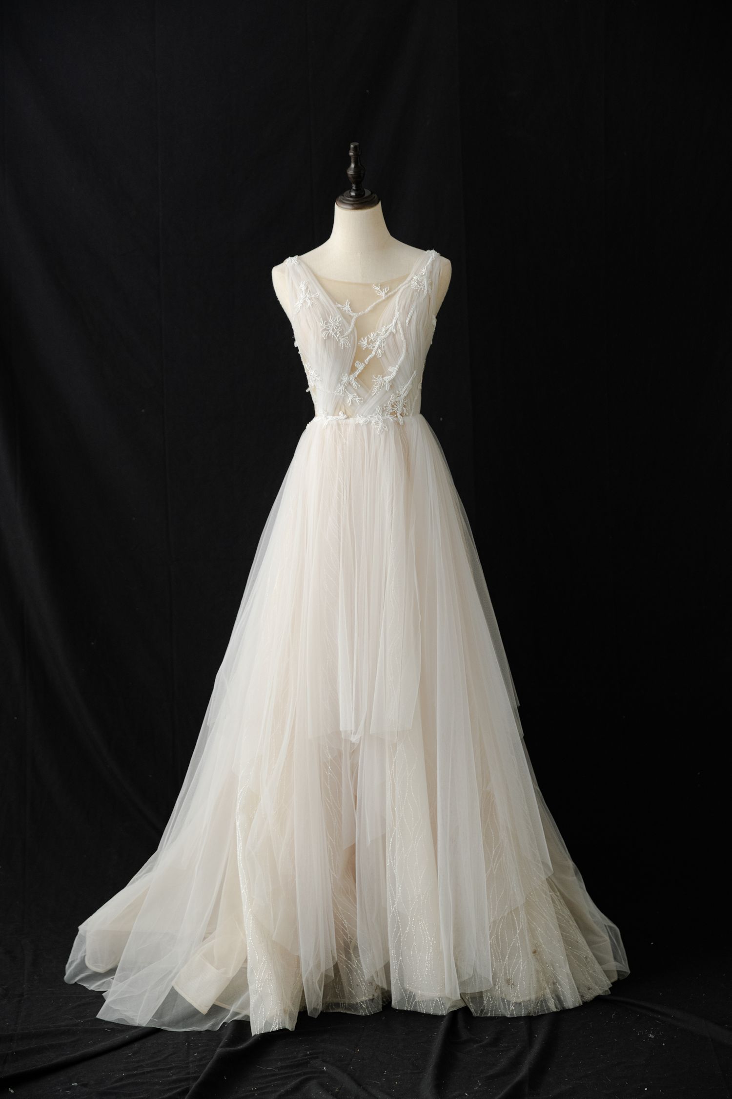 Flowing tulle wedding gown with embroidered bodice shown from multiple angles.