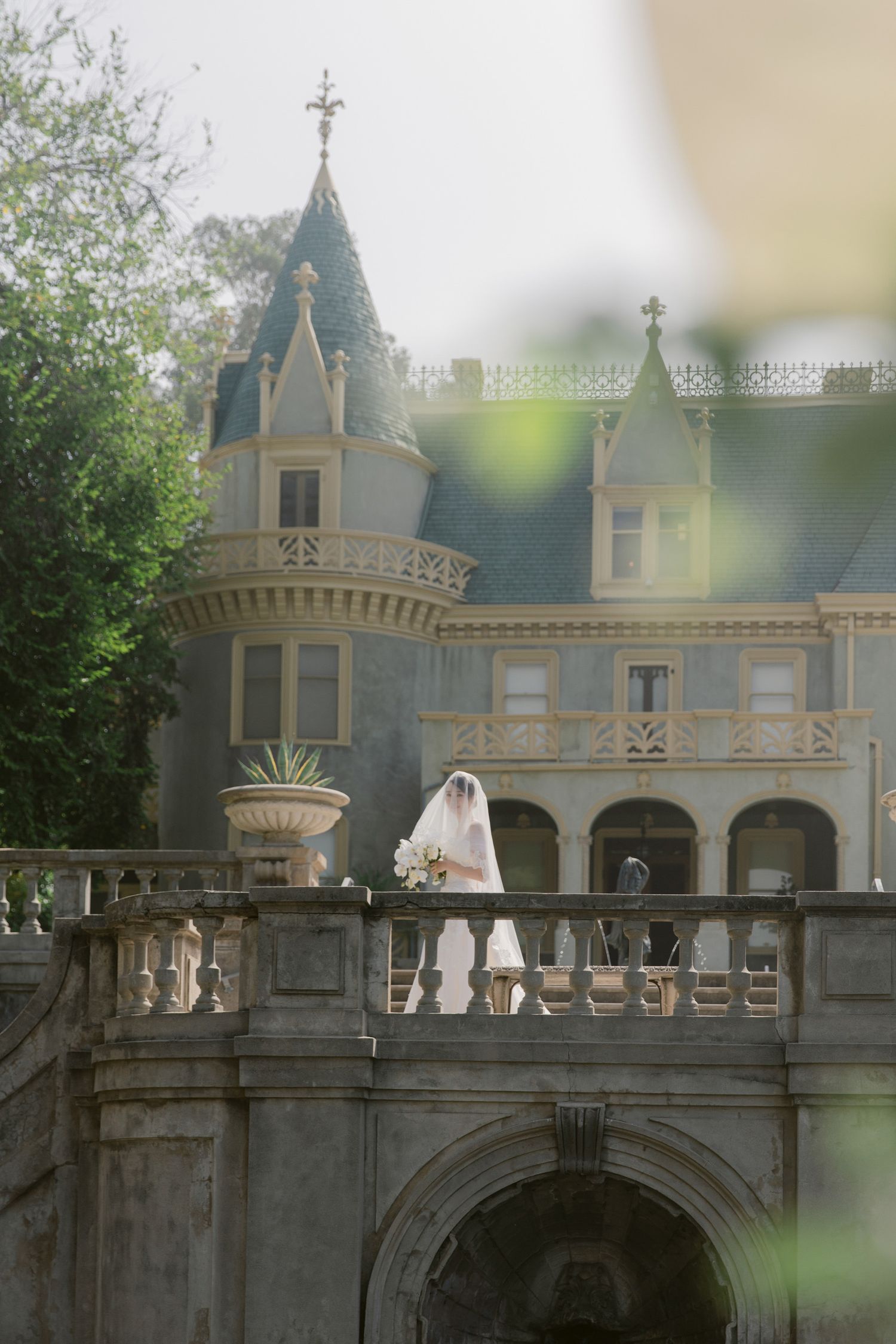 Fairytale wedding venue with stone architecture and turrets in natural daylight.