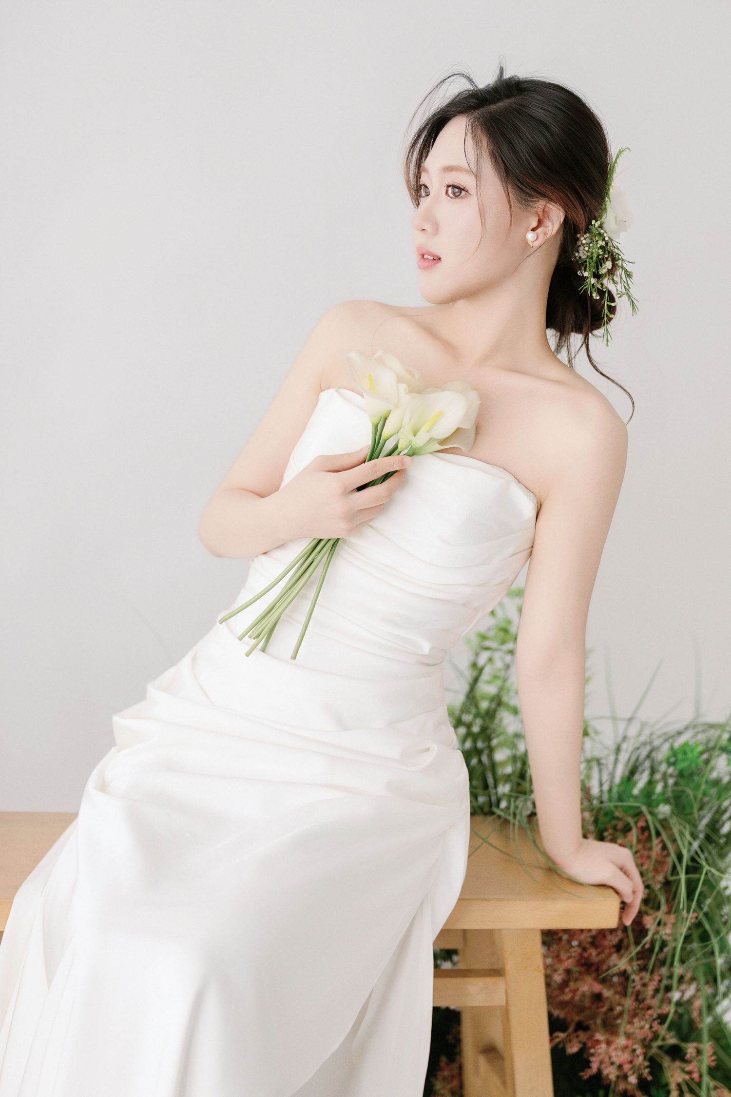 Romantic bridal session featuring strapless white dress and natural garden elements.