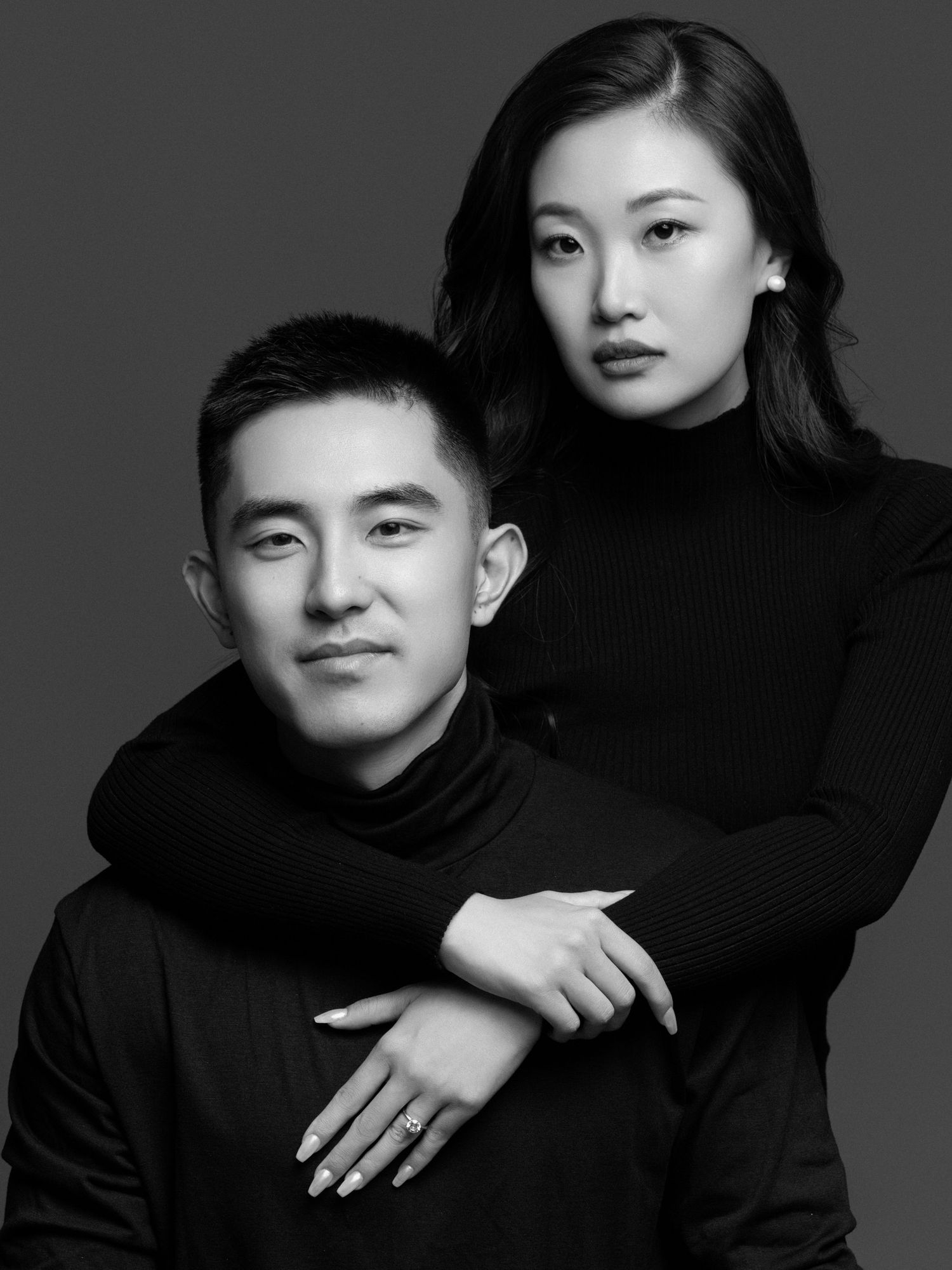 Moody black and white studio portraits showing artistic poses in turtleneck sweaters.
