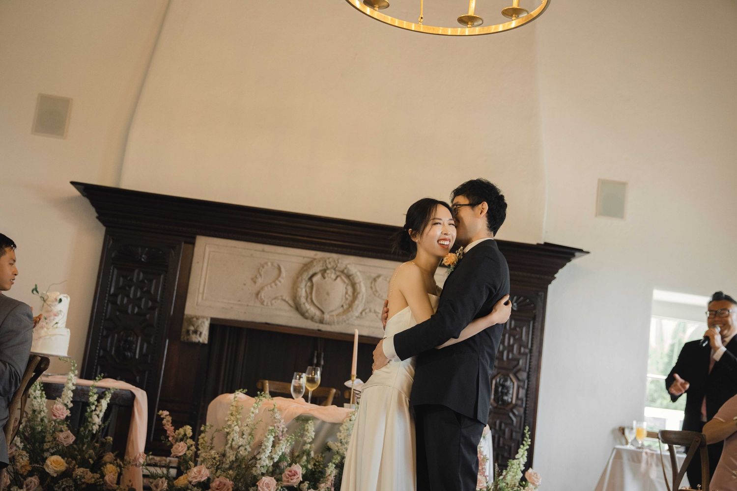 Wedding reception venue with elegant lighting and decorative details.
