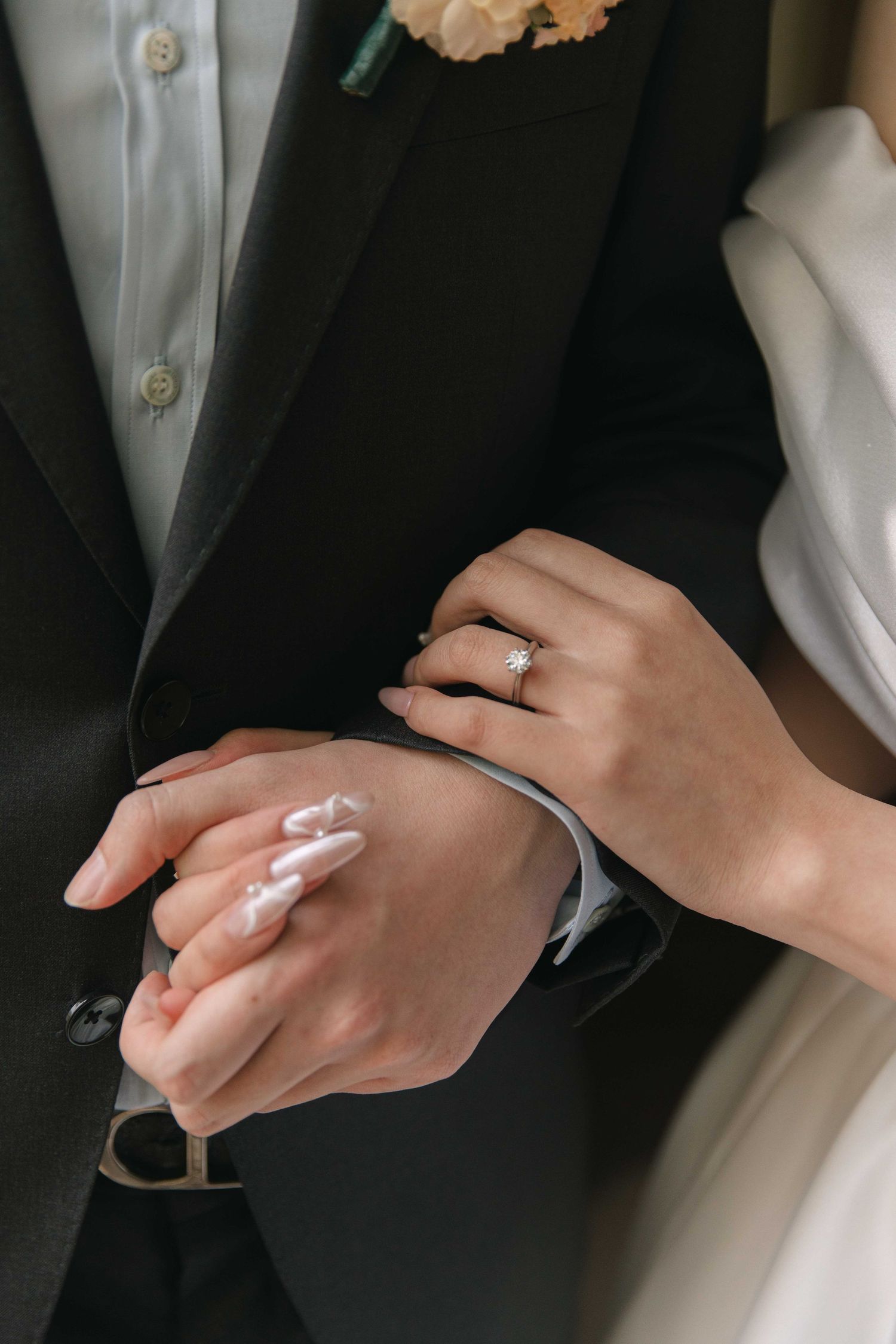 Close-up shots of hands exchanging wedding rings during a ceremony.