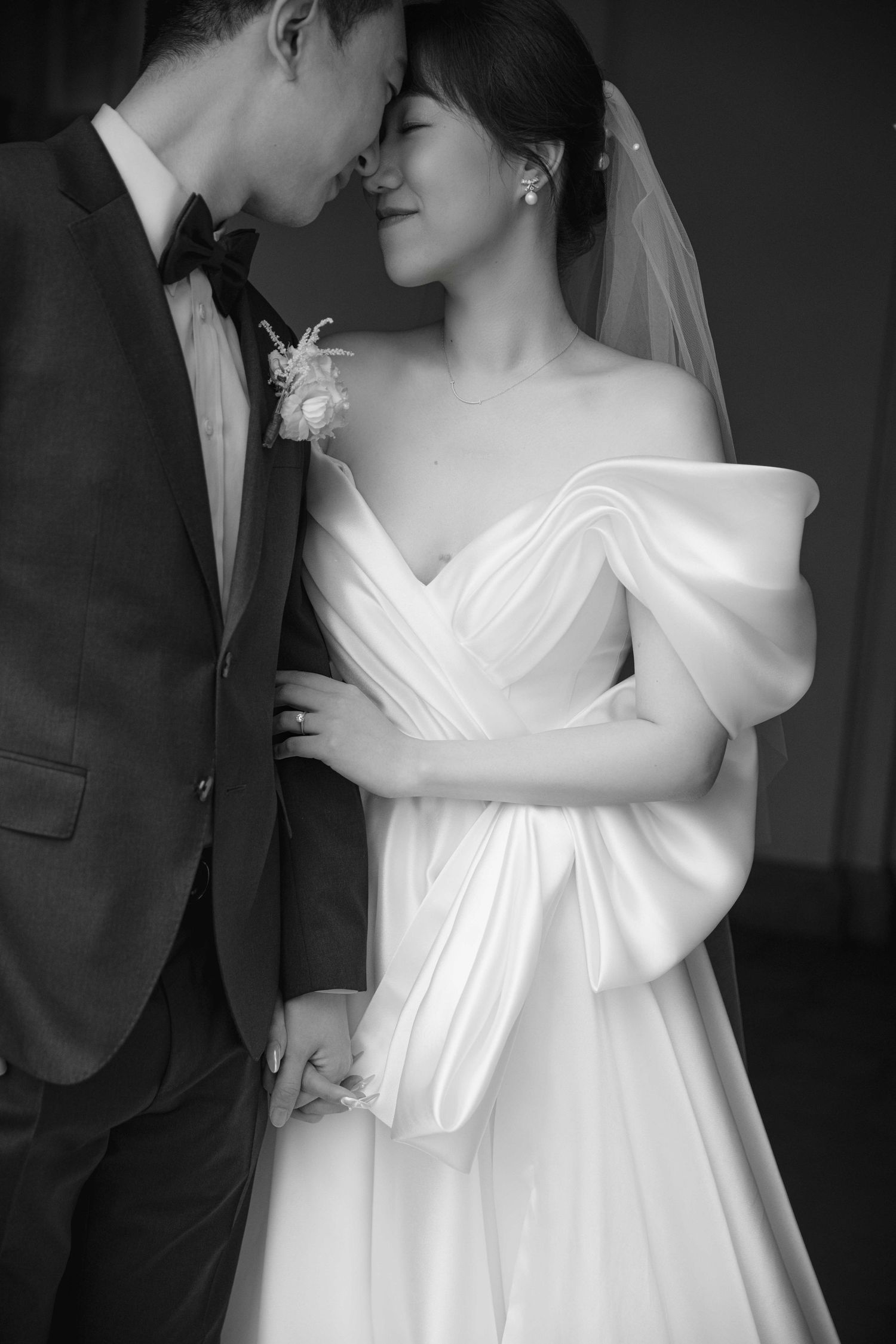 Black and white wedding portraits showing romantic close-up moments between newlyweds.