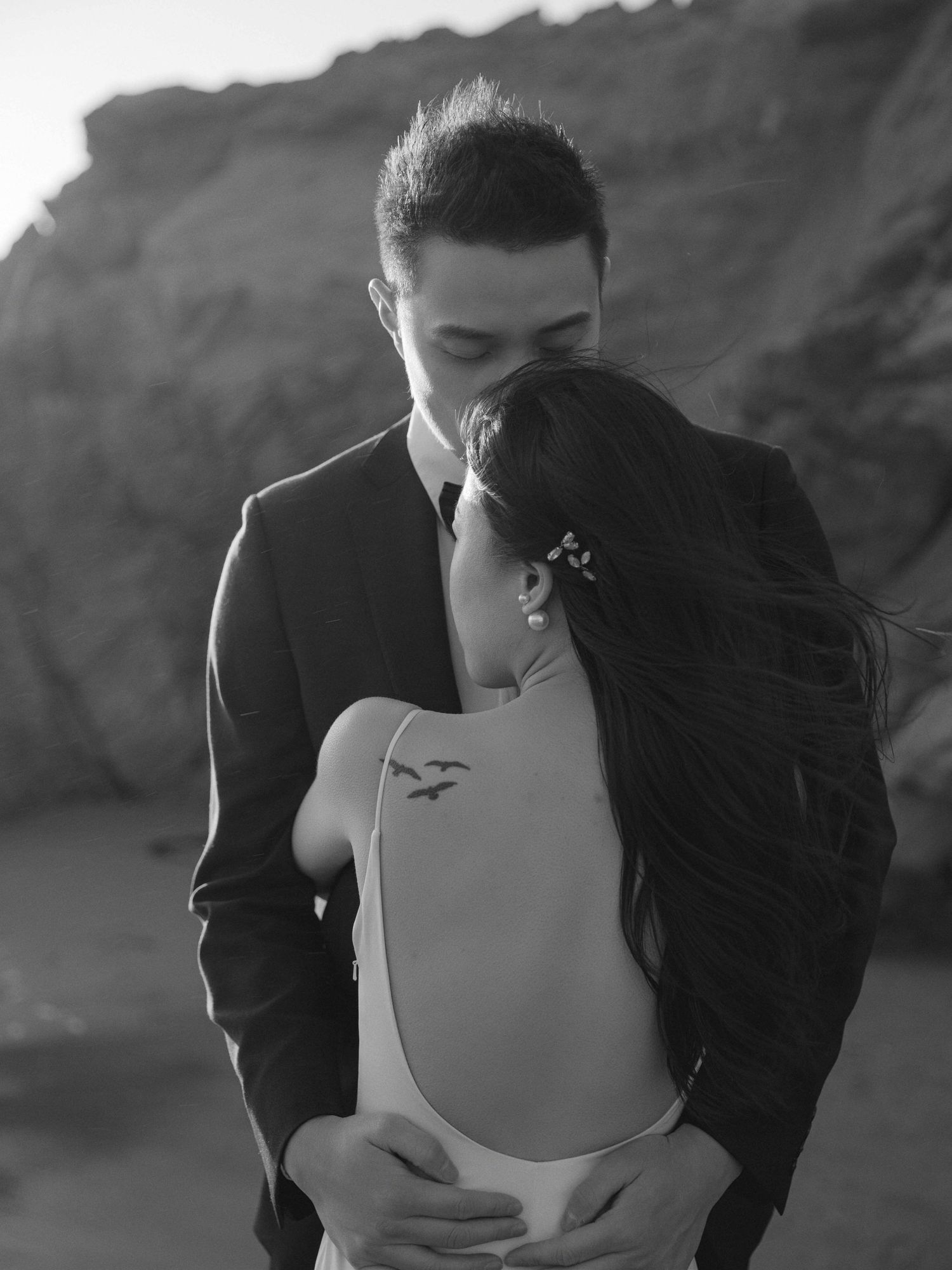 Intimate black and white portrait of a couple embracing on their wedding day.