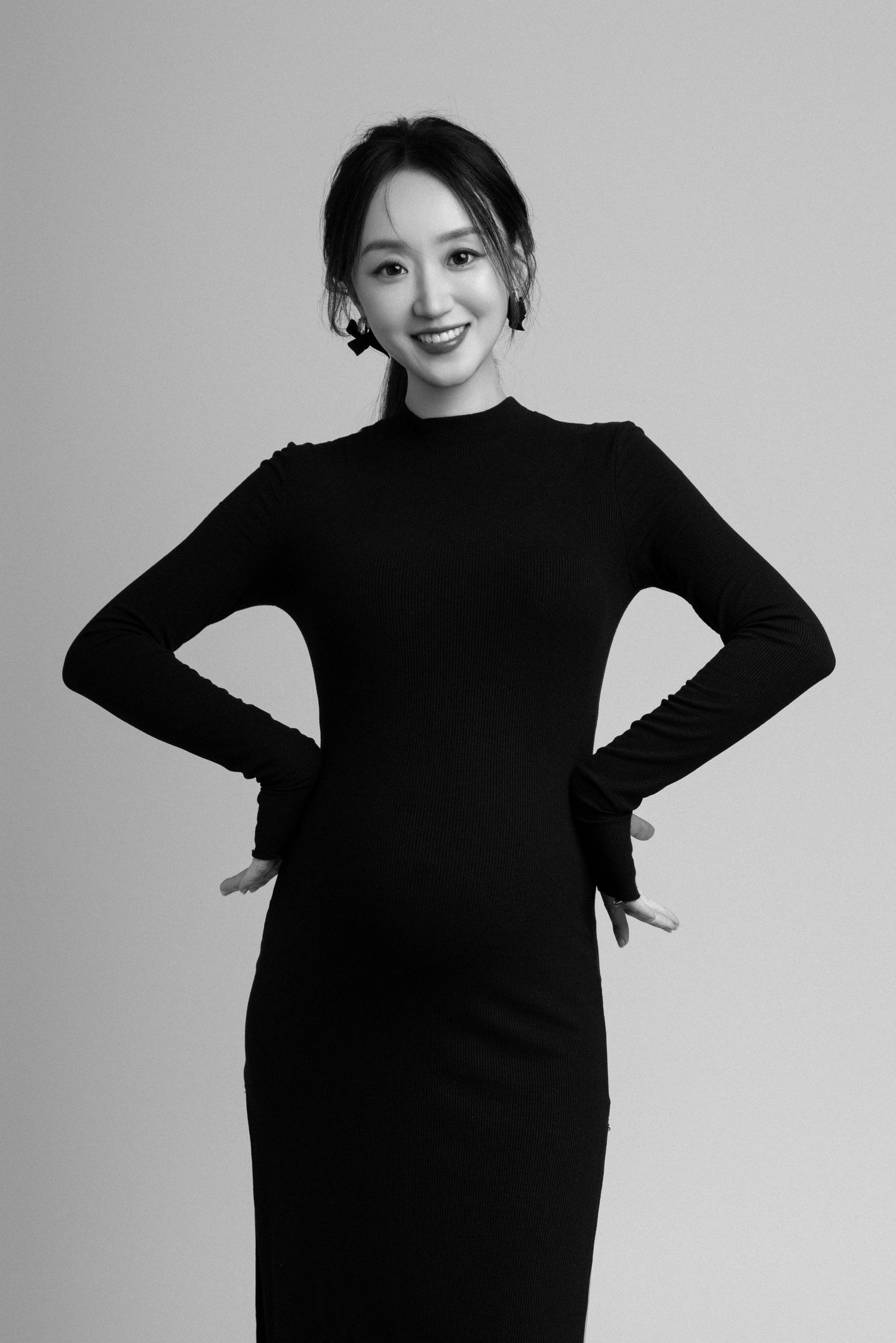 Modern black and white maternity portraits showing playful poses.