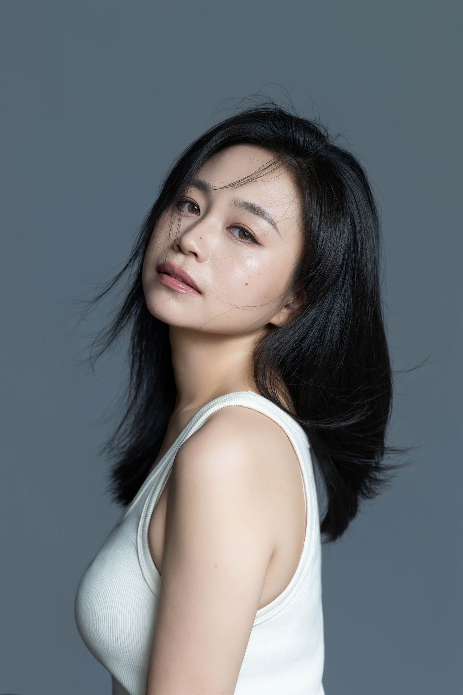 Elegant beauty portrait with soft lighting and natural styling.