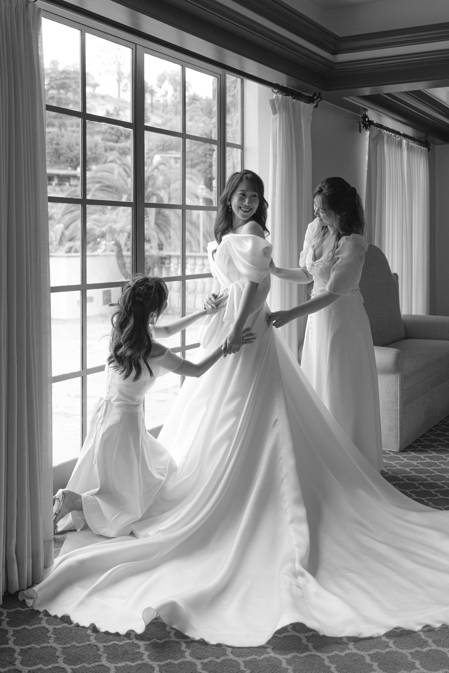 Black and white series of flowing wedding dress movement captured near window.