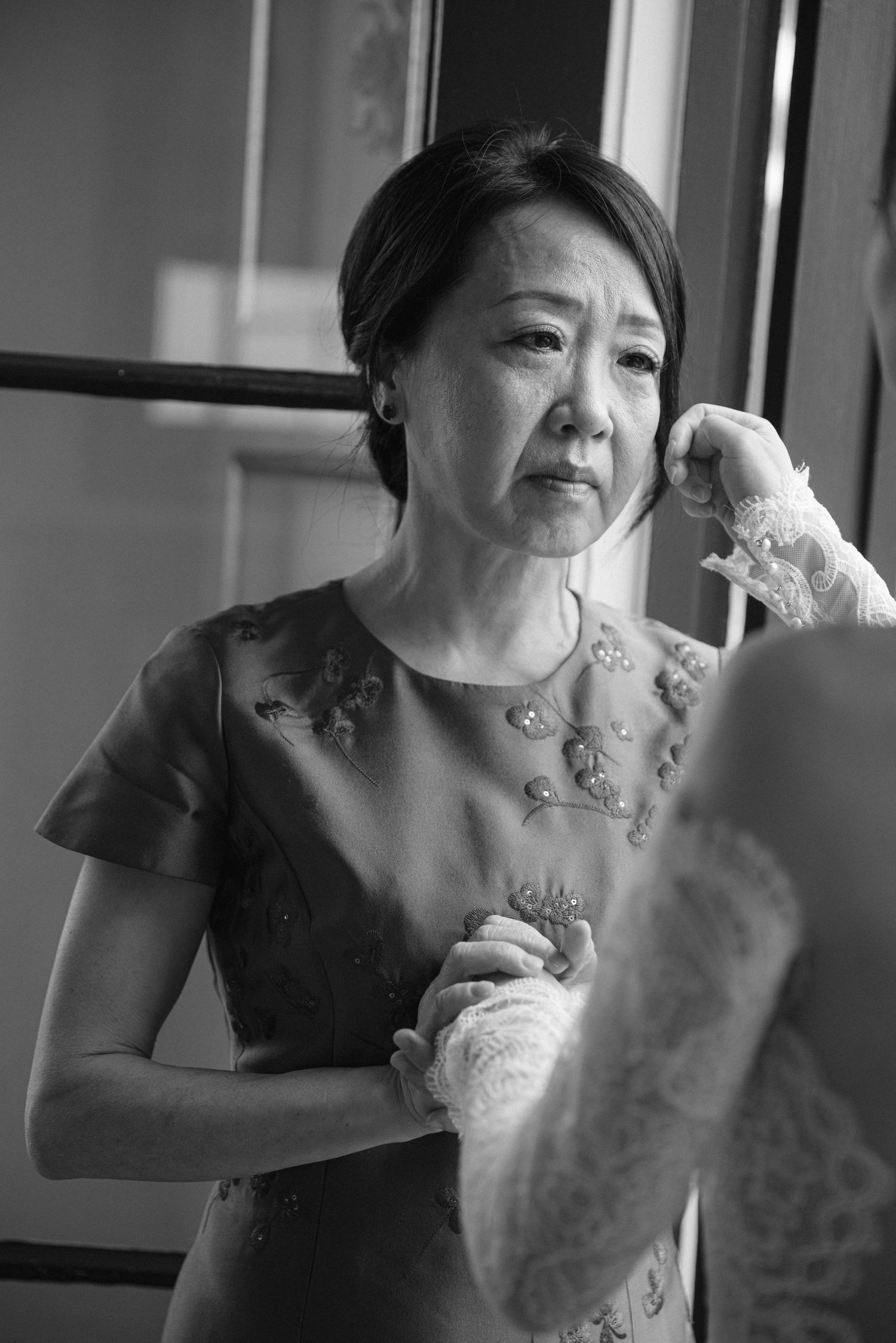 An elegant bridal portrait captured in black and white showing intricate lace details.