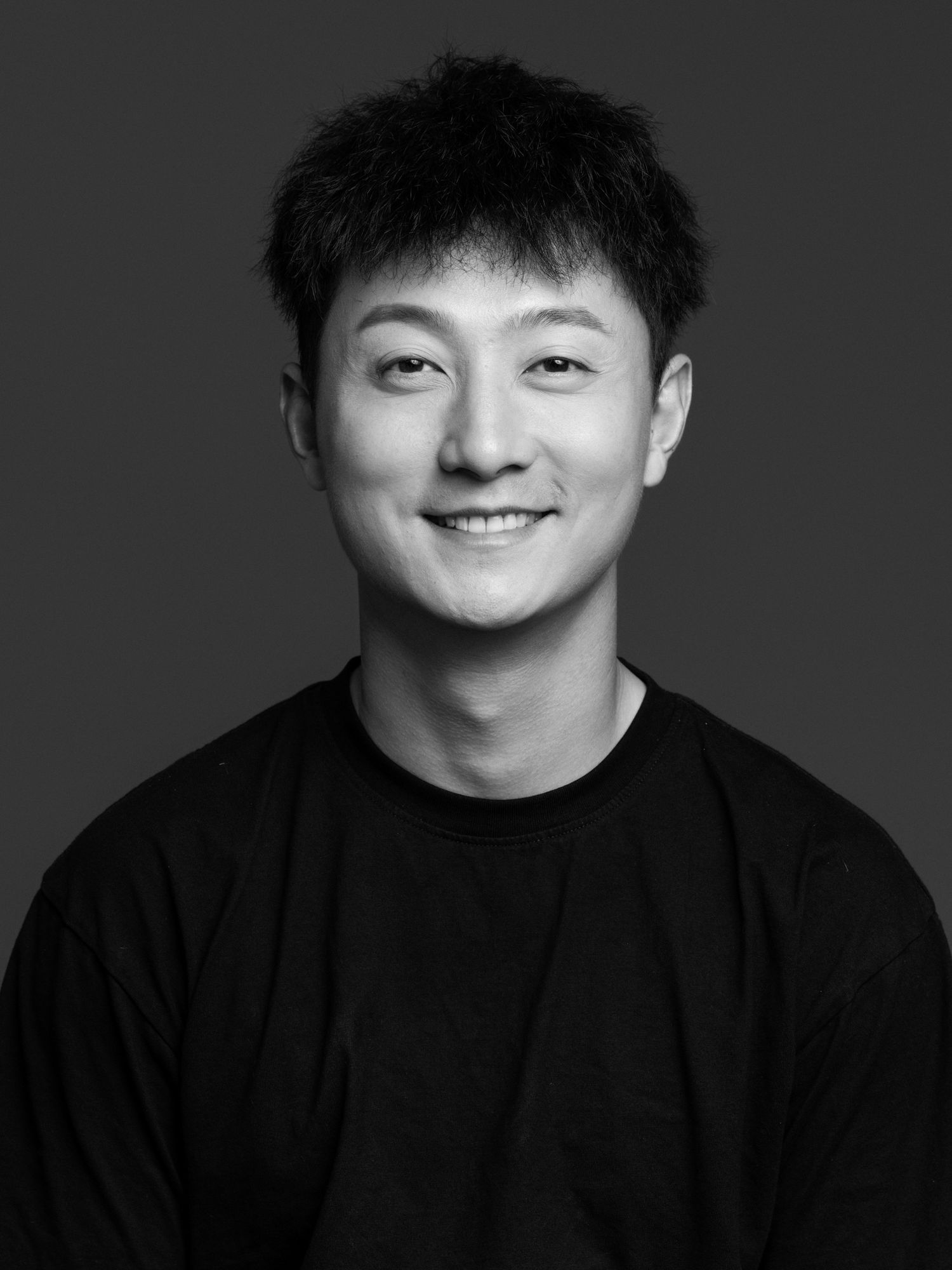 Black and white headshots showing joyful expressions against dark background.