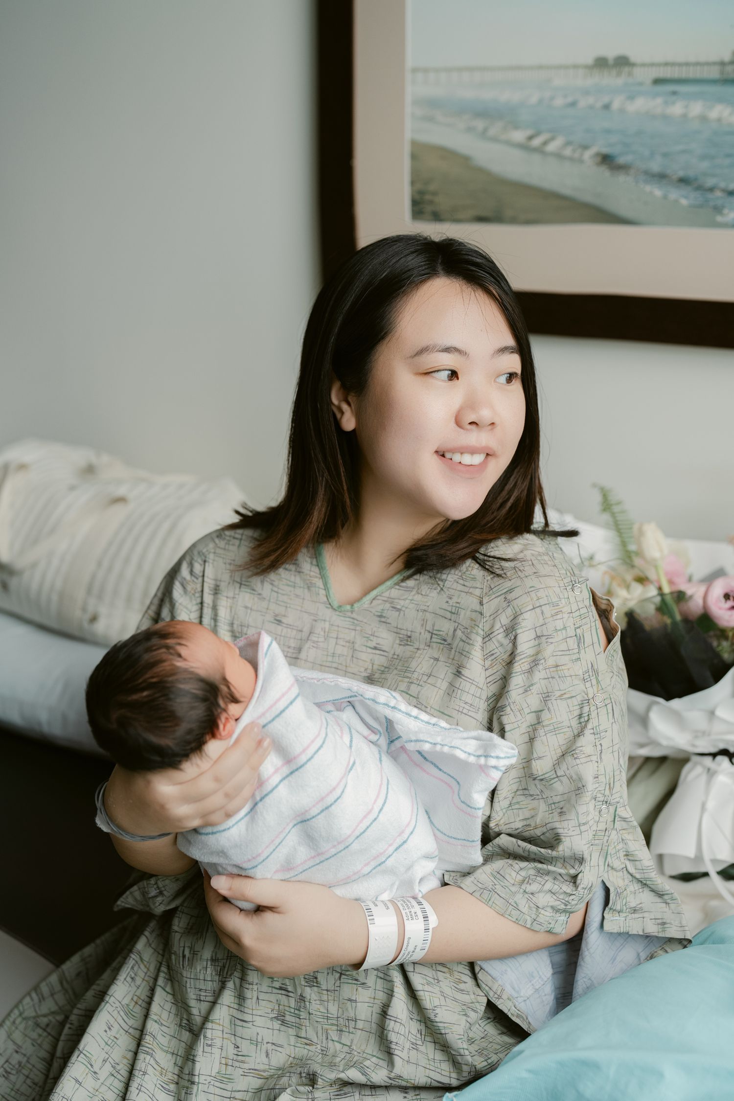 A mother resting with her newborn baby in a bright, peaceful room.