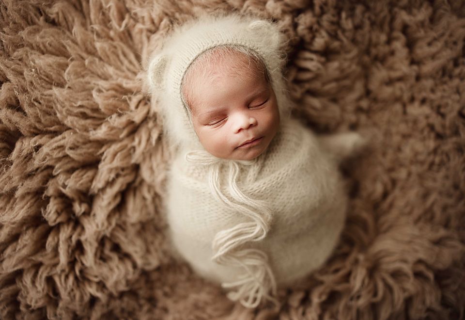 Newborn baby wrapped in cream swaddle on fluffy newborn photographer Richmond Chesterfield midlothian Petersburg glen Allen short pump
