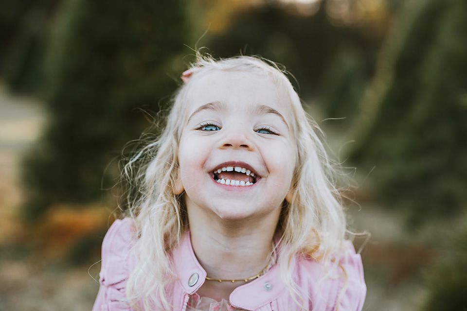 Happy blonde girl in pink laughing outdoors. midlothian family photographer