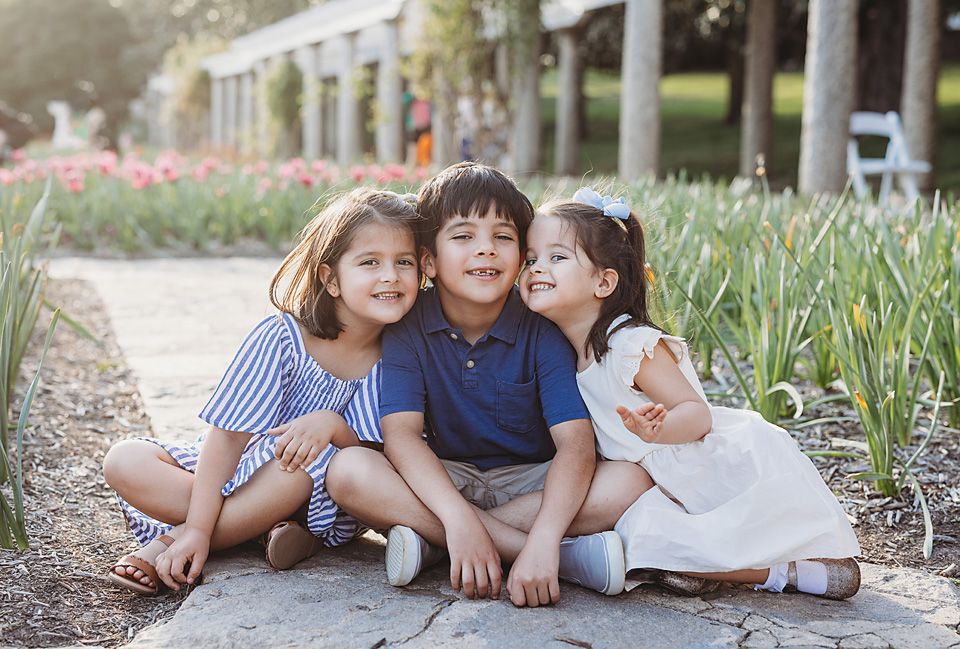 Three siblings hugging and smiling in a garden path Richmond family photographer, midlothian, glen Allen, short pump