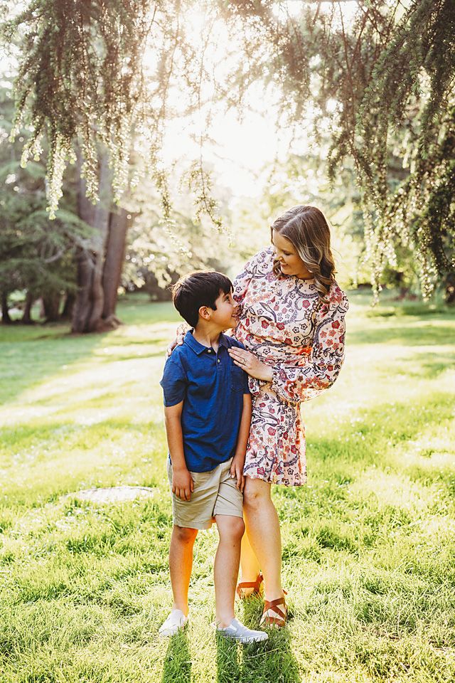 Boy in blue polo looking up at mother in sunny park Richmond family photographer, midlothian, glen Allen, short pump