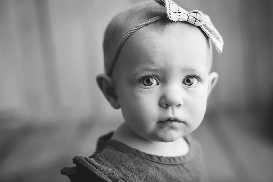 Close-up black and white portrait of baby girl with bow headband and big expressive eye Richmond family photographer, midlothian, glen Allen