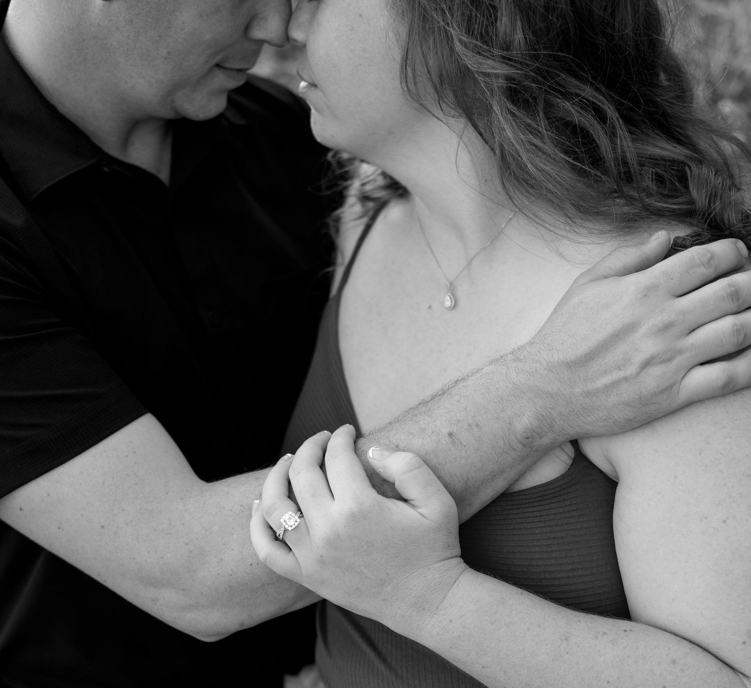 Intimate black and white close-up of couple embracing.