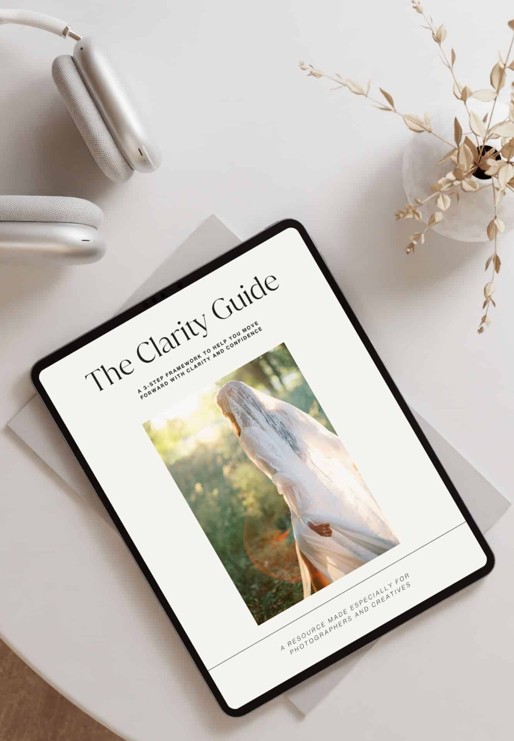 The Clarity Guide digital resource for photographers displayed on tablet with headphones nearby.