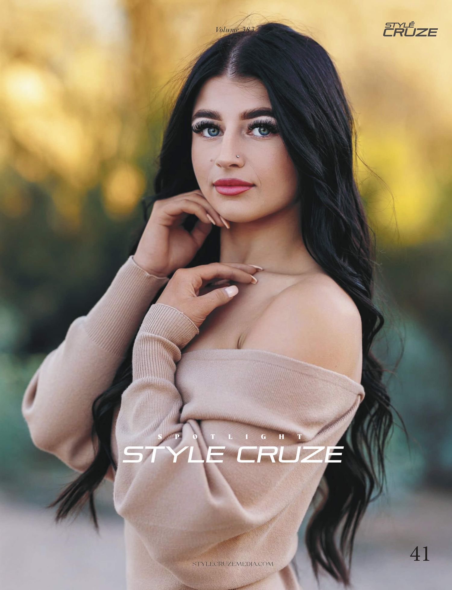 Dark-haired woman in off-shoulder beige sweater poses for Style Cruze magazine portrait.
