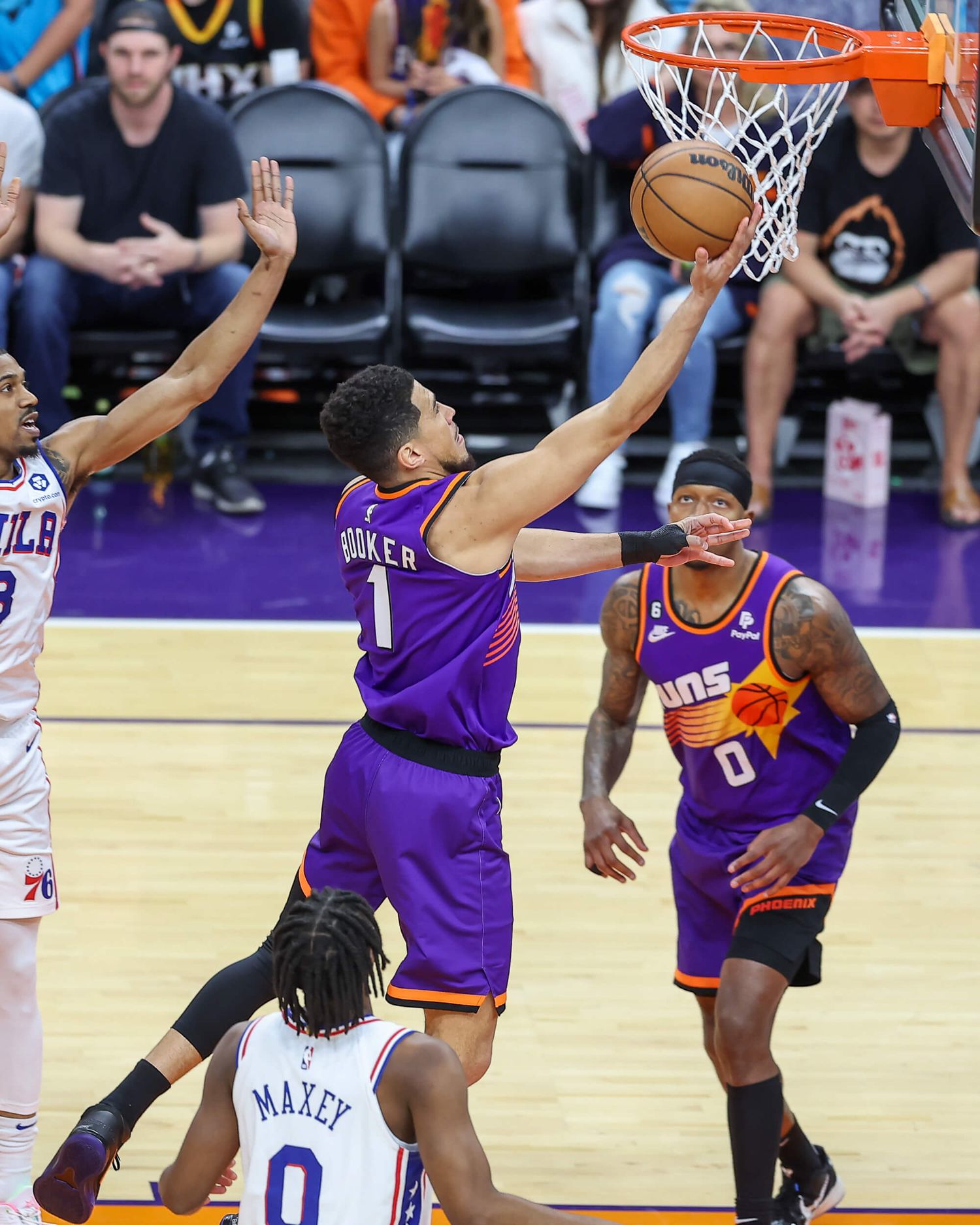Devin Booker #1 of Phoenix Suns drives to basket against Philadelphia 76ers.