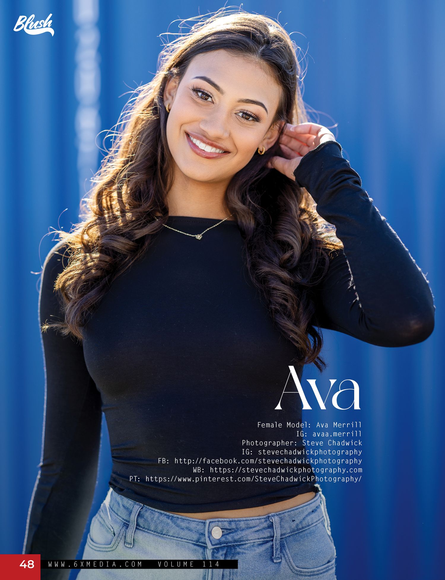 Young woman named Ava poses confidently in a black long-sleeve top against a blue corrugated metal wall.