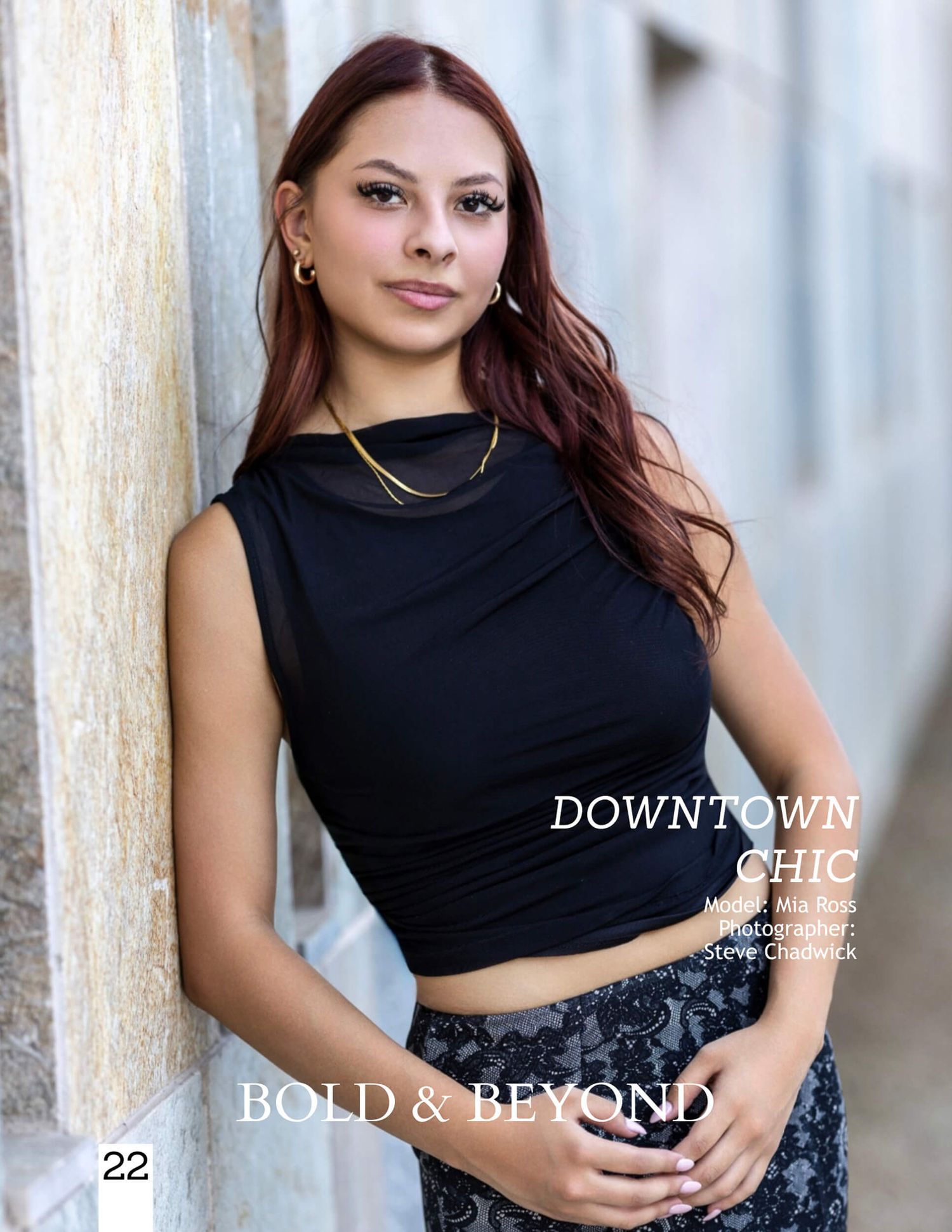 Young woman in black crop top and patterned skirt poses outdoors for Bold & Beyond magazine Downtown Chic editorial.