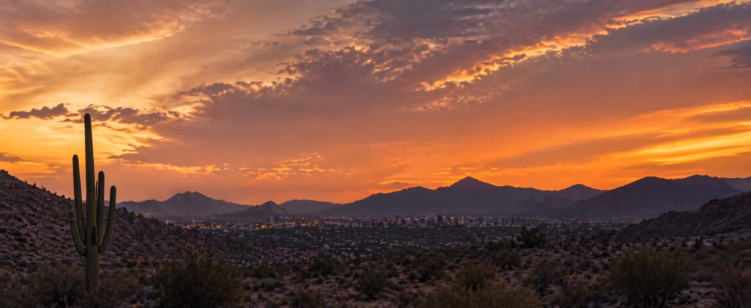 Vibrant Arizona desert sunset with saguaro cactus and mountain silhouettes.