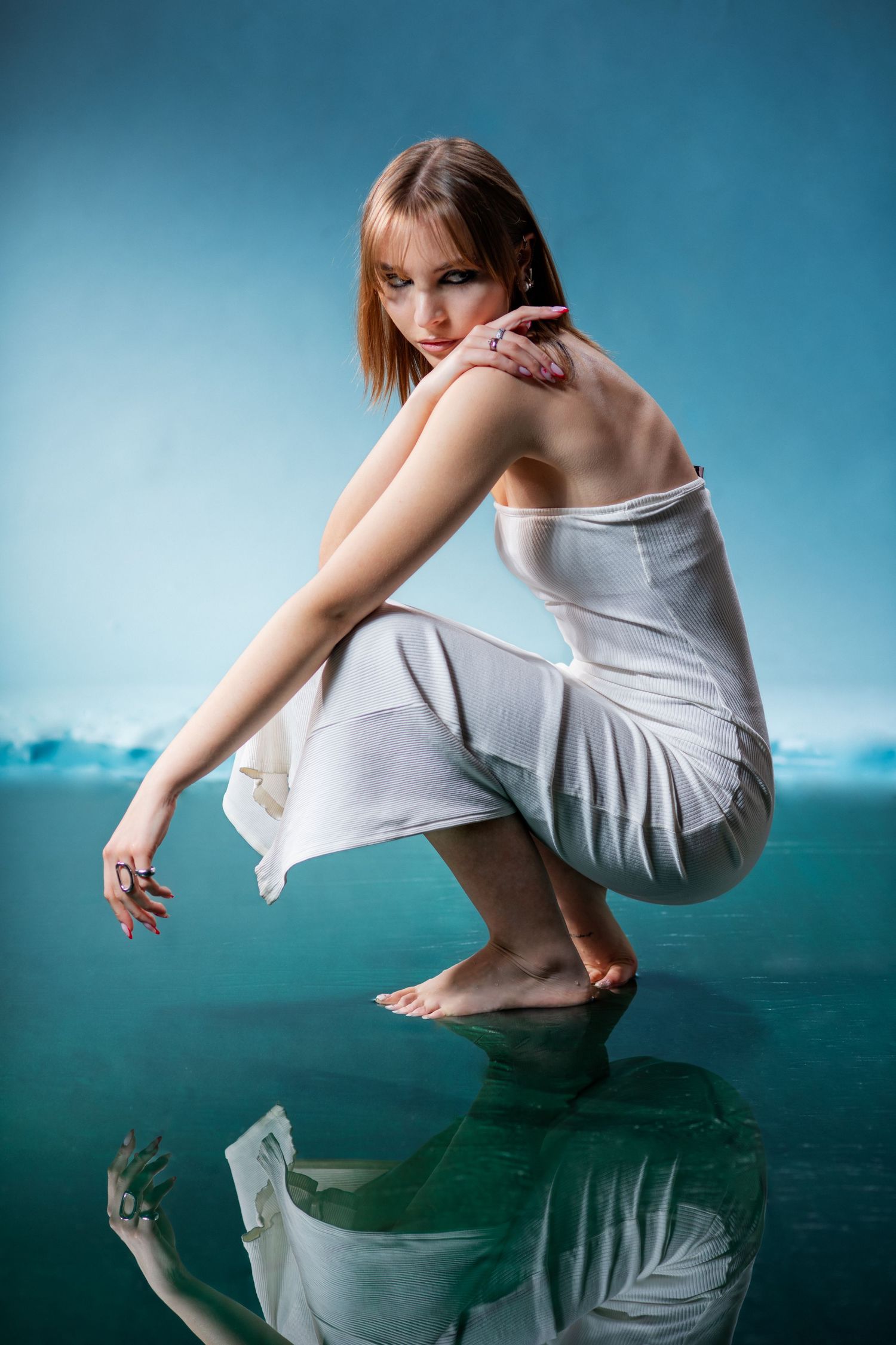 Artistic fashion portrait with reflective floor and cinematic atmosphere