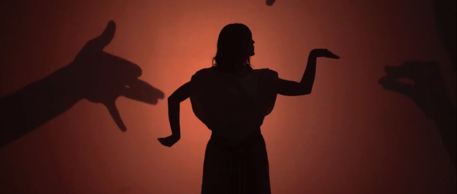 Cinematic performance scene with theatrical lighting and creative visual storytelling.