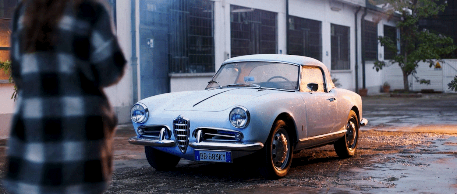 Vintage car featured in a cinematic fashion film with warm golden-hour lighting and editorial composition.