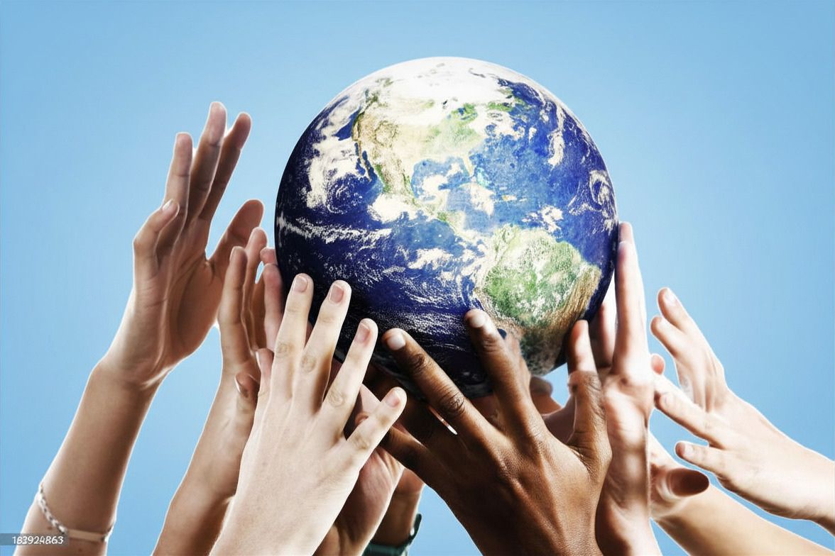 Diverse hands reaching up together to hold a globe, symbolizing global unity and cooperation.