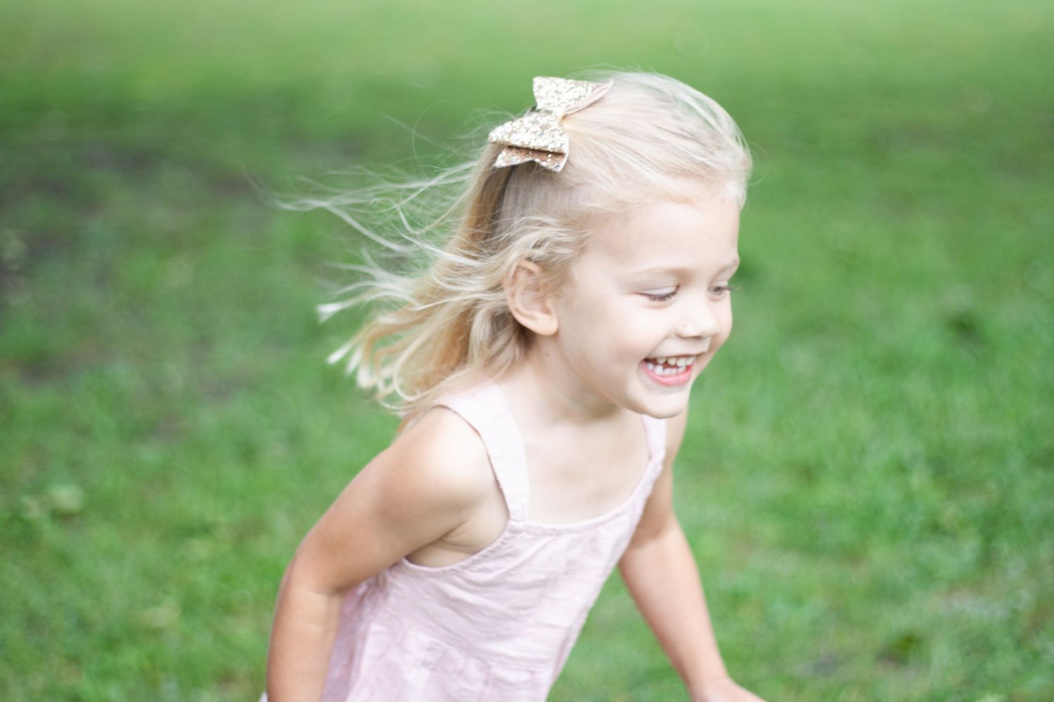 Vibrant outdoor family photography of a young girl running at Chisholm Trail Park in Plano, Texas.