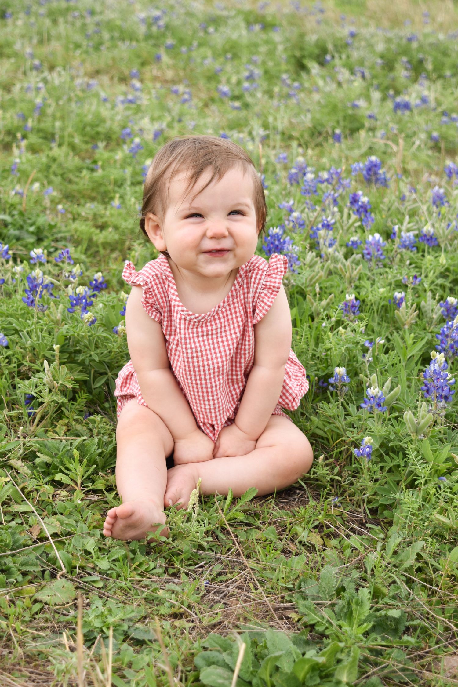 Happy baby girl during a vibrant outdoor sunset bluebonnet session at Arbor Hills Nature Preserve.