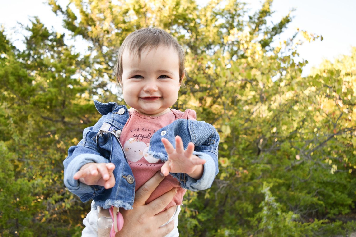 Smiling baby girl during a natural, true-to-life newborn portrait session in North Dallas.