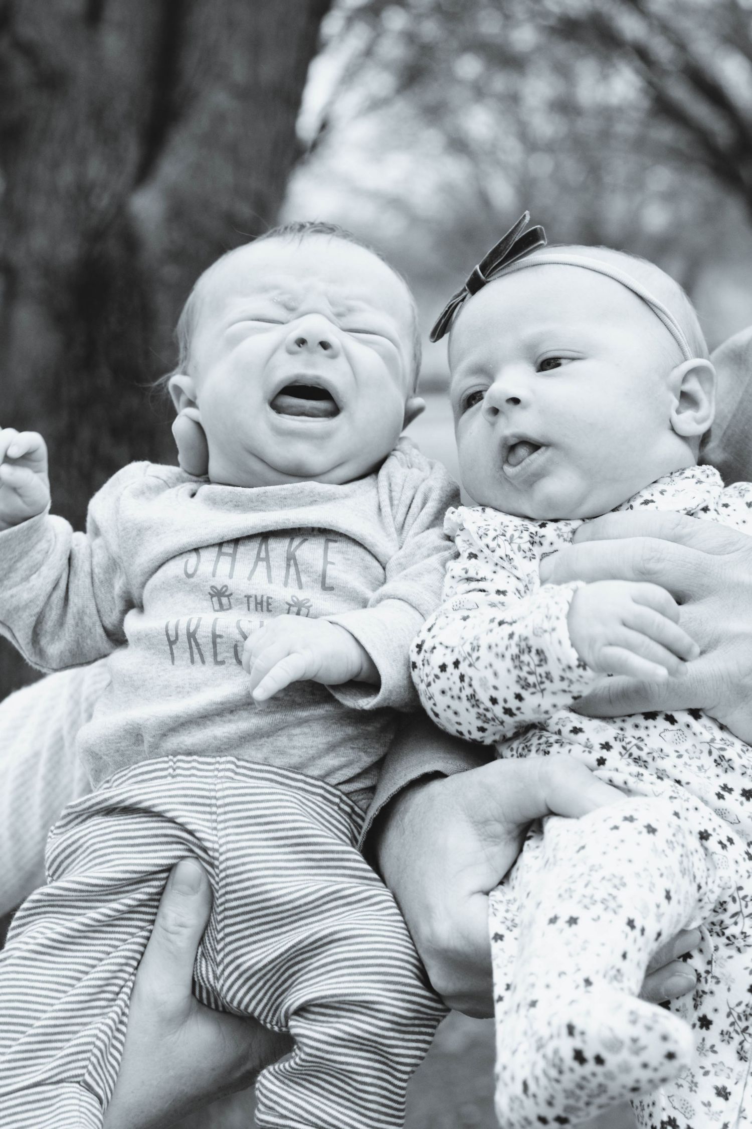 Newborn baby boy and newborn baby girl captured during a vibrant outdoor sunset session by a North Dallas newborn photographer.