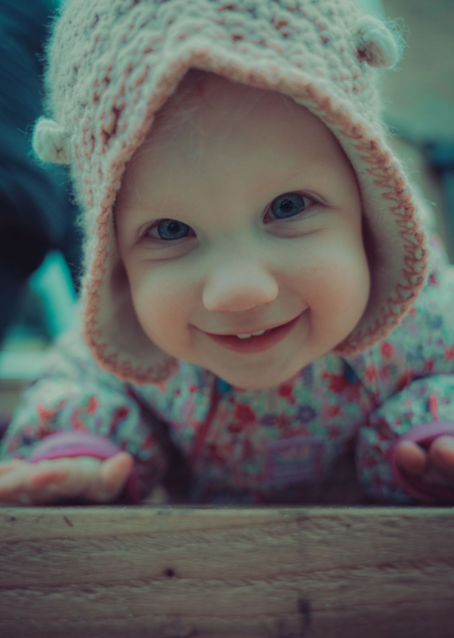 Close-up series of baby wearing knit hat showing adorable expressions.