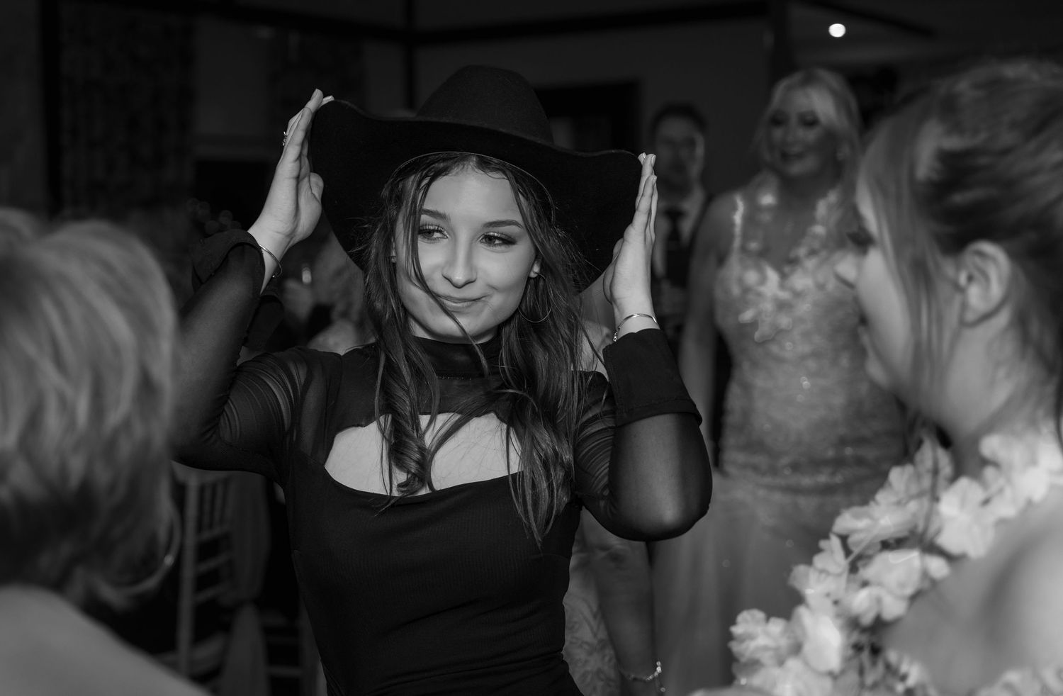 Black and white candid shots of dancing and celebration at wedding reception.