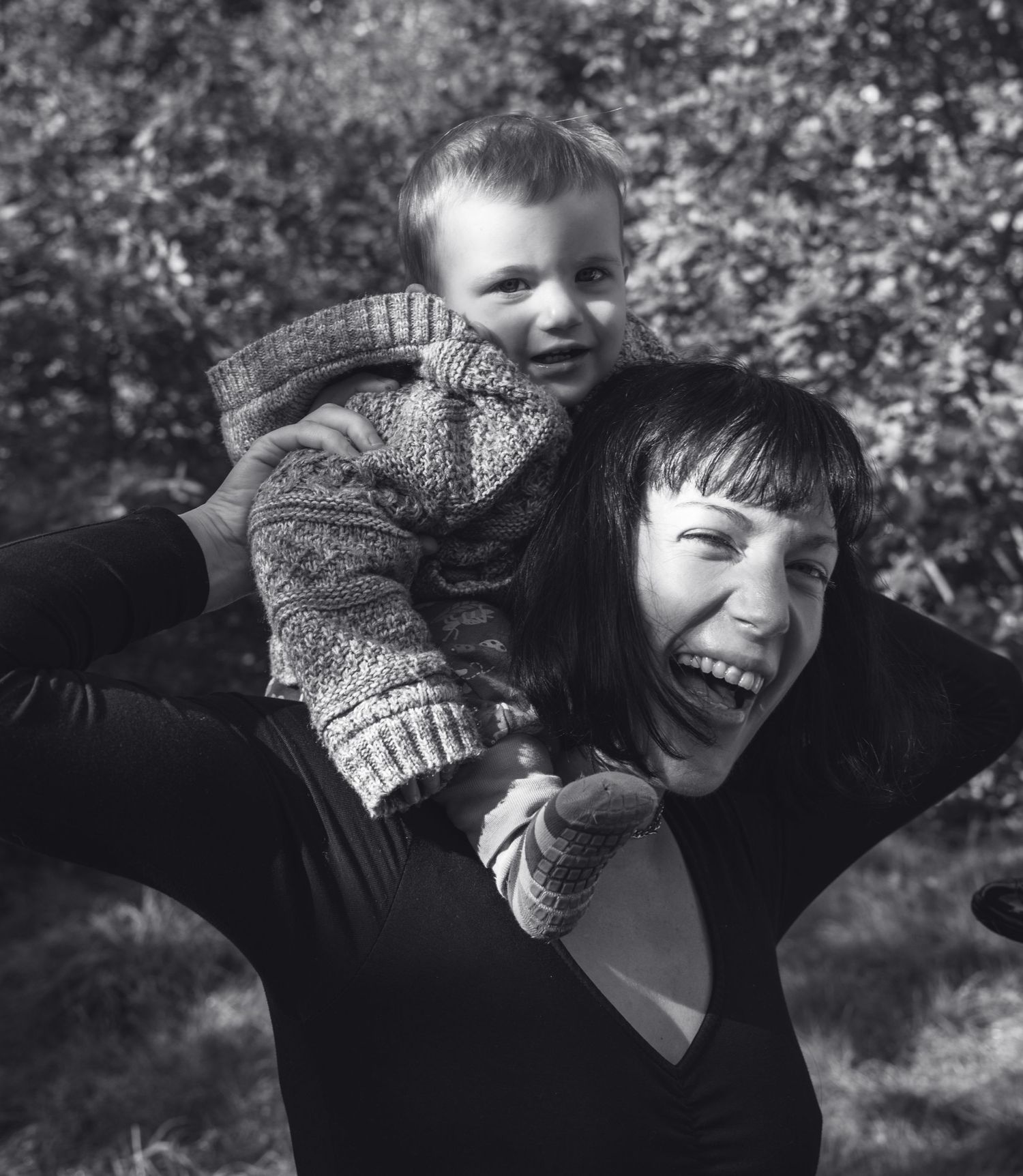 Playful black and white portraits showing joyful expressions with winter accessories.