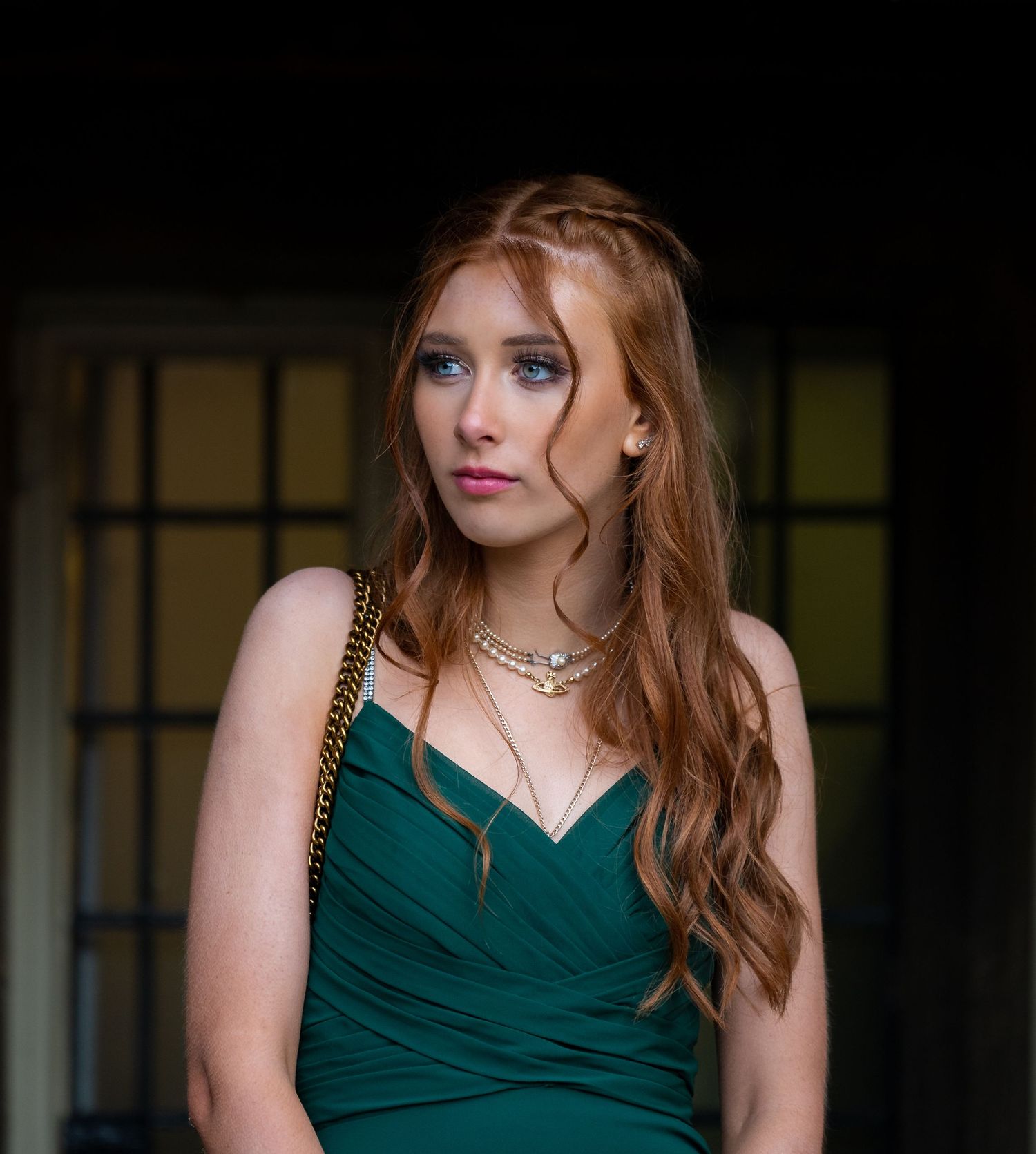 Woman in emerald green evening dress poses elegantly in a series of glamour shots.