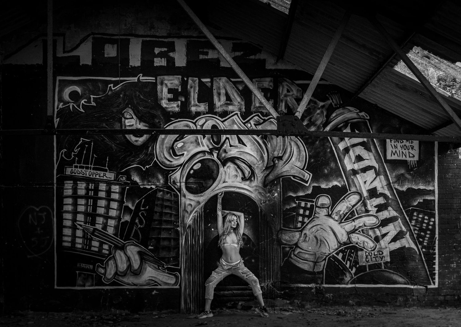 Urban wall covered in detailed graffiti art and murals at night.