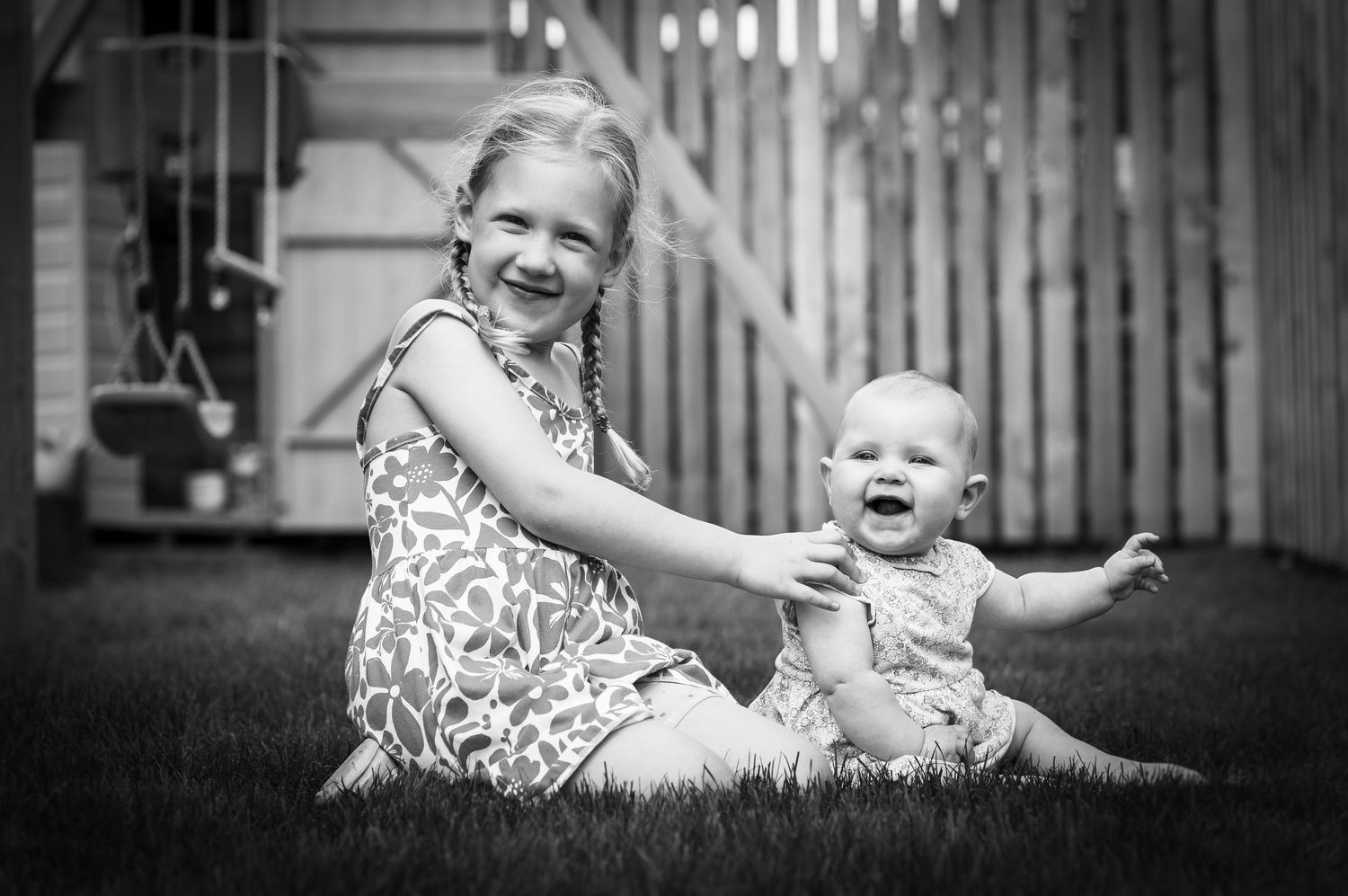 Black and white sequence of playful moments on wooden deck.