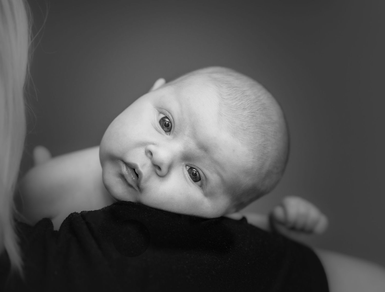 Black and white artistic portrait series showing close-up details in dramatic lighting.