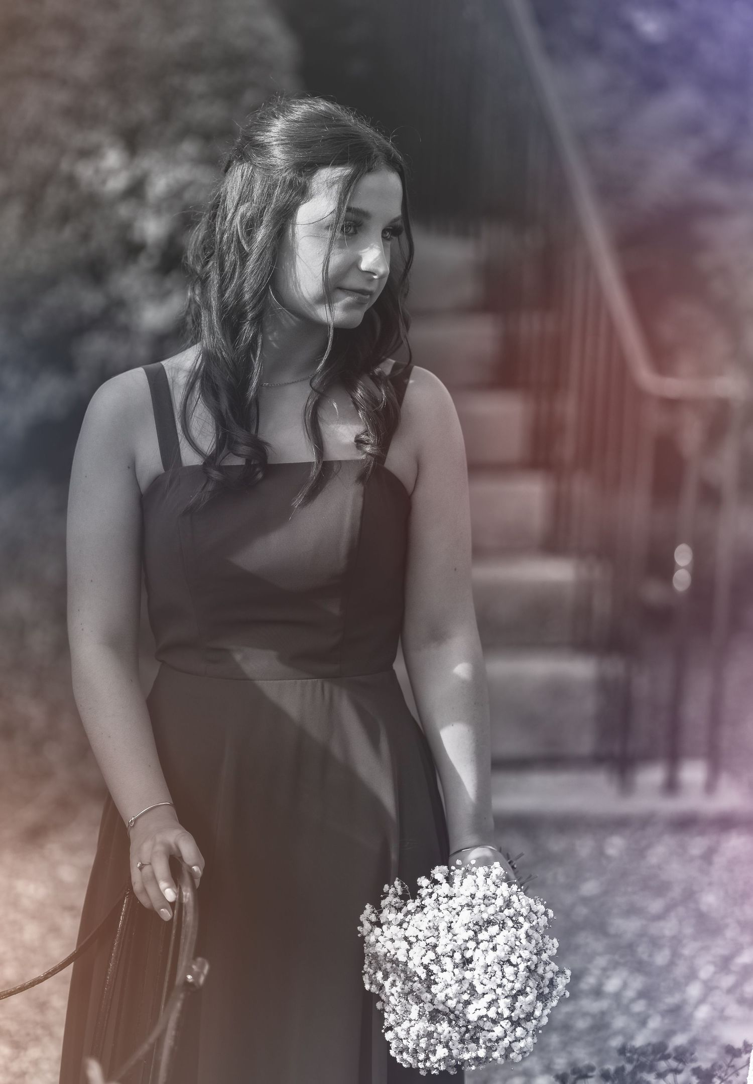 Artistic black and white photos of someone holding white flowers against a dark background.