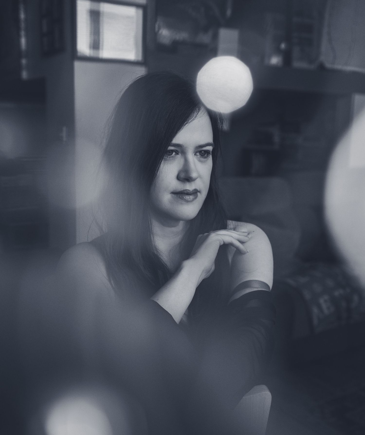 Moody portrait series with bokeh light effects in blue tones.