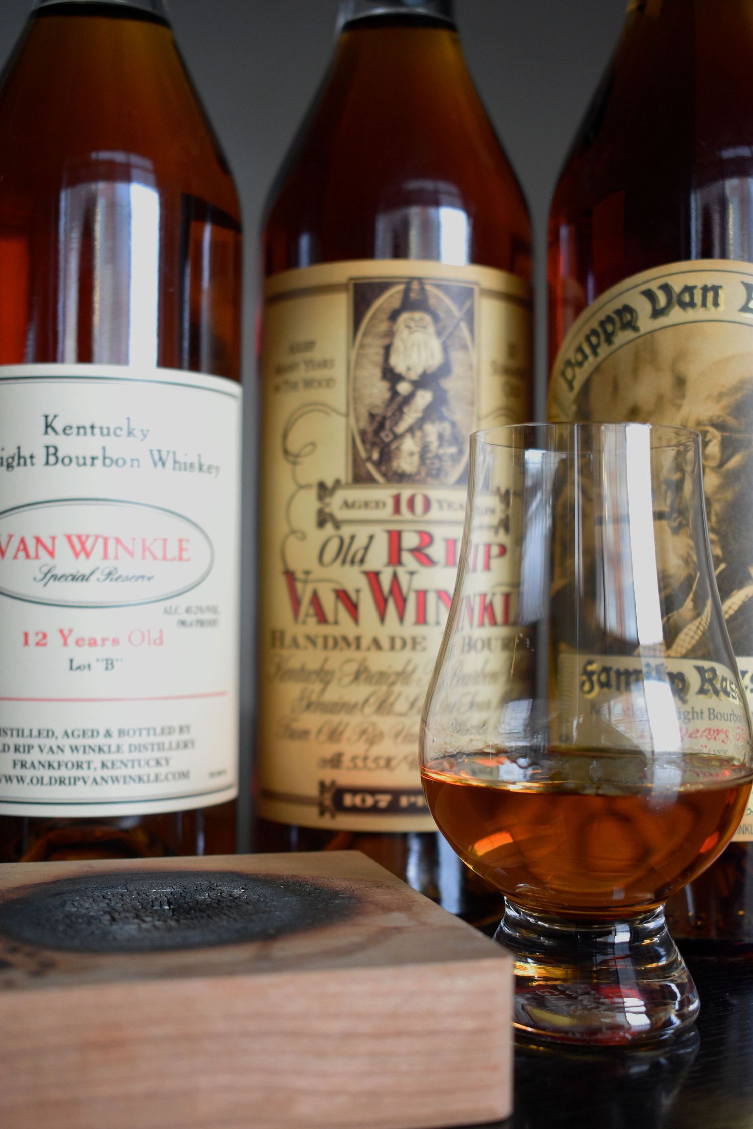 Van Winkle Special Reserve 12-year and Old Rip Van Winkle bourbon bottles with a Glencairn tasting glass.