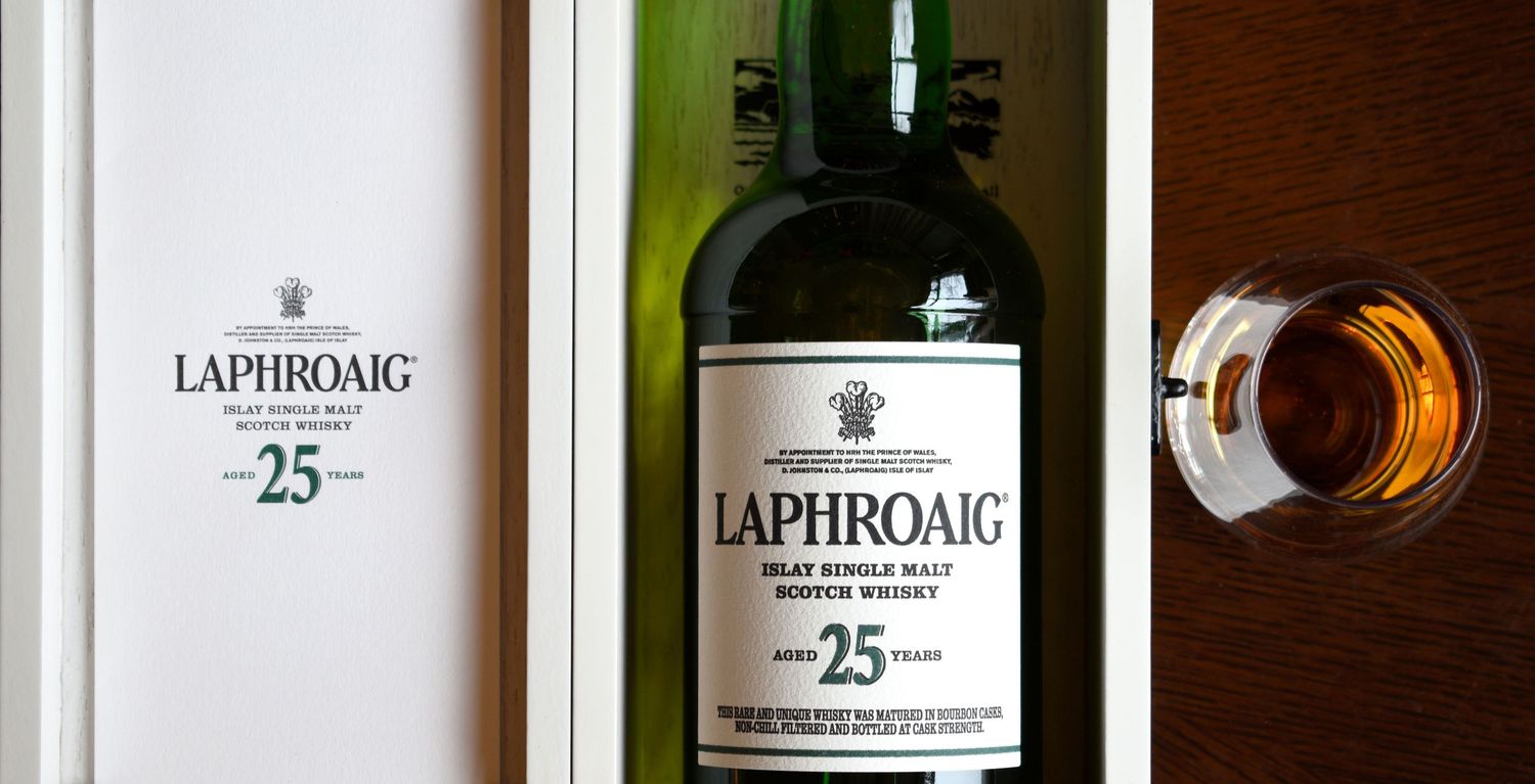 Laphroaig 25 Year Islay Single Malt Scotch Whisky bottle displayed in its elegant white wooden presentation box.