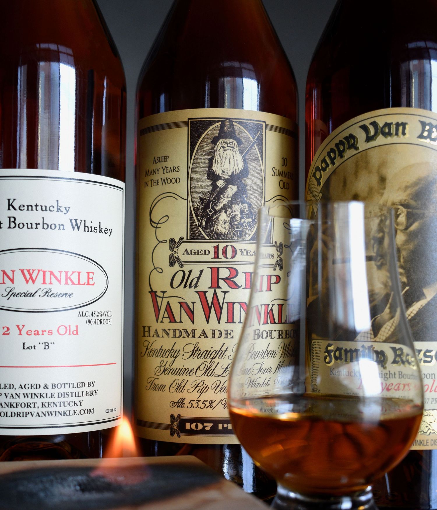 Old Rip Van Winkle 10-year and Pappy Van Winkle Family Reserve bourbon bottles with a Glencairn glass.