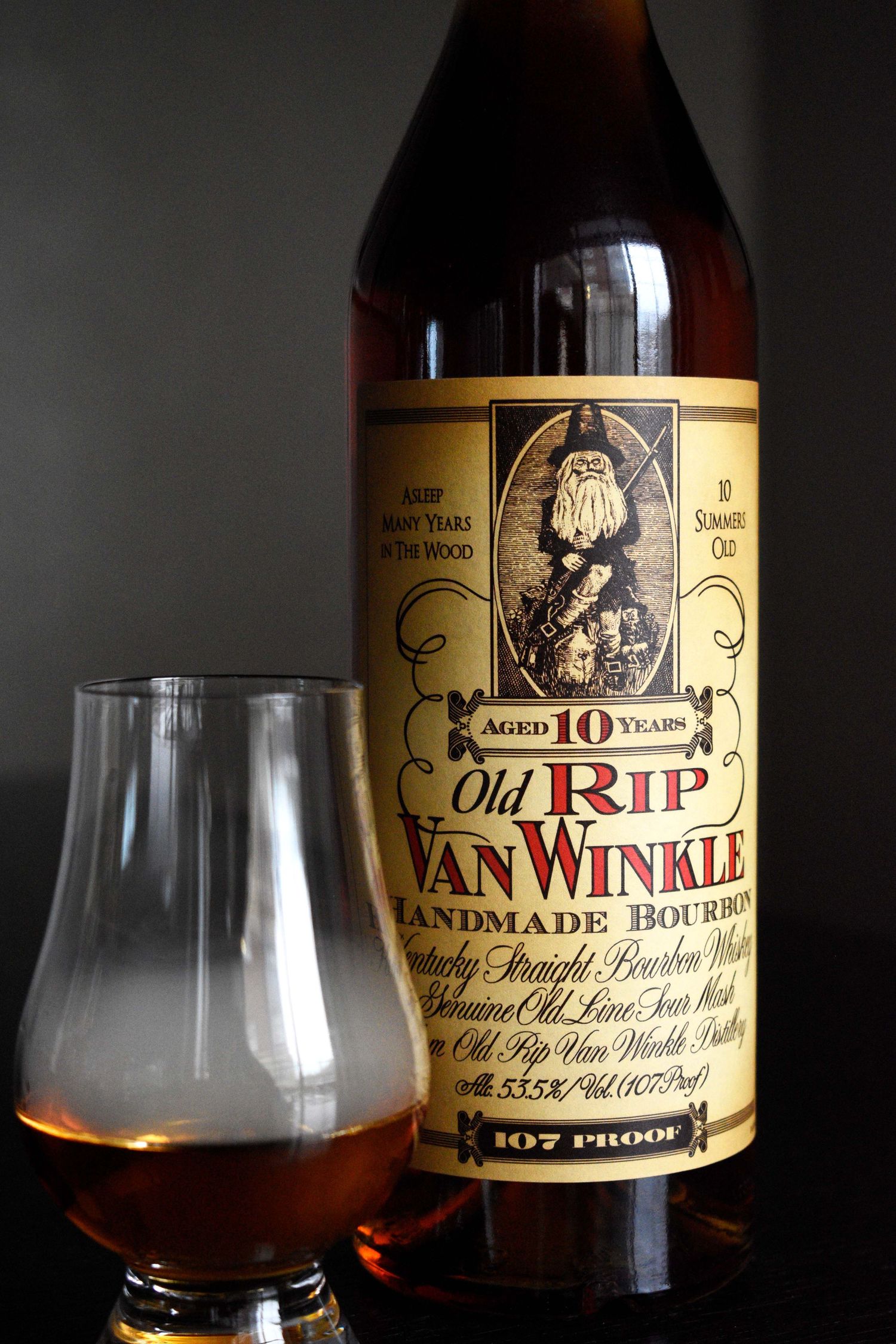 Old Rip Van Winkle 10-year handmade bourbon whiskey bottle beside a Glencairn tasting glass.