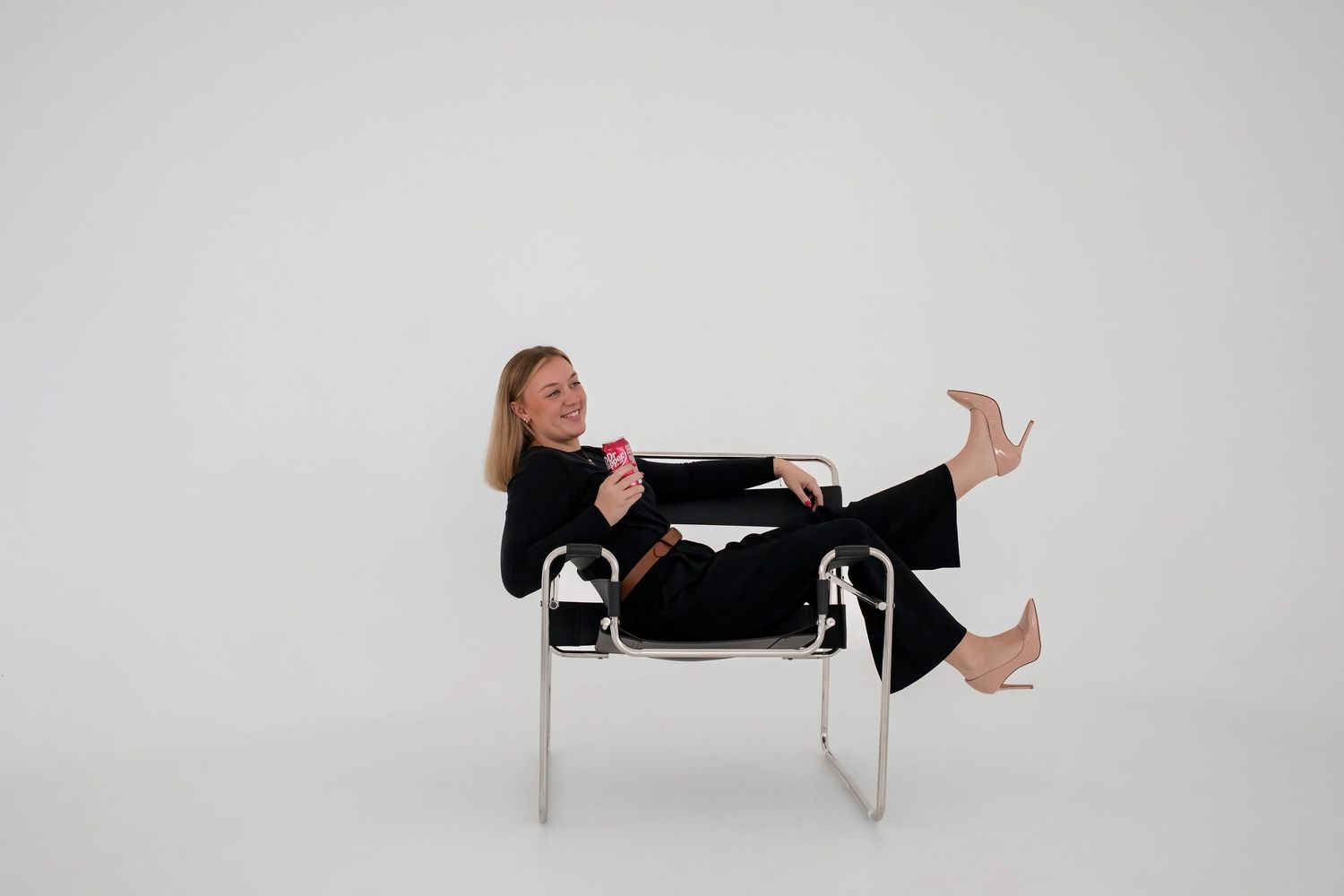 Image of Becka sitting in chair with Dr Pepper